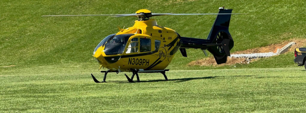 PHI Air Medical helicopter landing in open field emergency landing zone