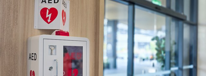 Automated external defibrillator mounted on a wall in a public building.