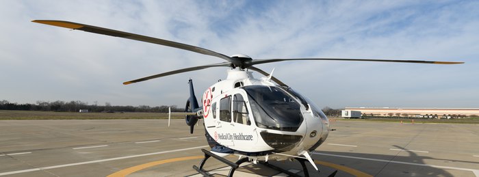 Medical City Healthcare branded helicopter on a hospital helipad, a cooperative air medical program aircraft flown by PHI Air Medical crews.