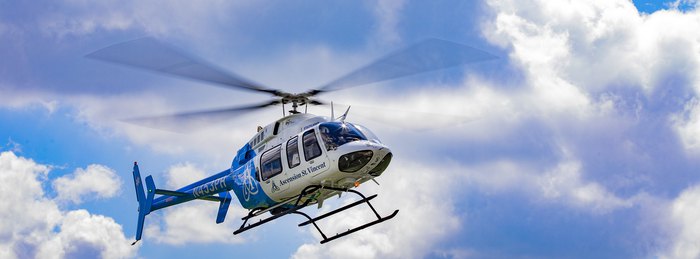 Ascension St. Vincent StatFlight helicopter in flight through cloud, a cooperative air medical program aircraft flown by PHI Air Medical crews.
