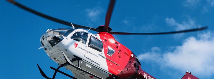 University Hospitals UH AirMed helicopter in flight, a cooperative air medical program aircraft flown by PHI Air Medical crews.